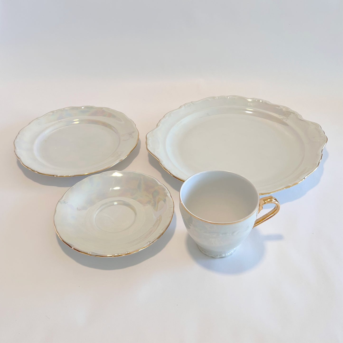Antique pearlescent four-piece tea set, sold as set